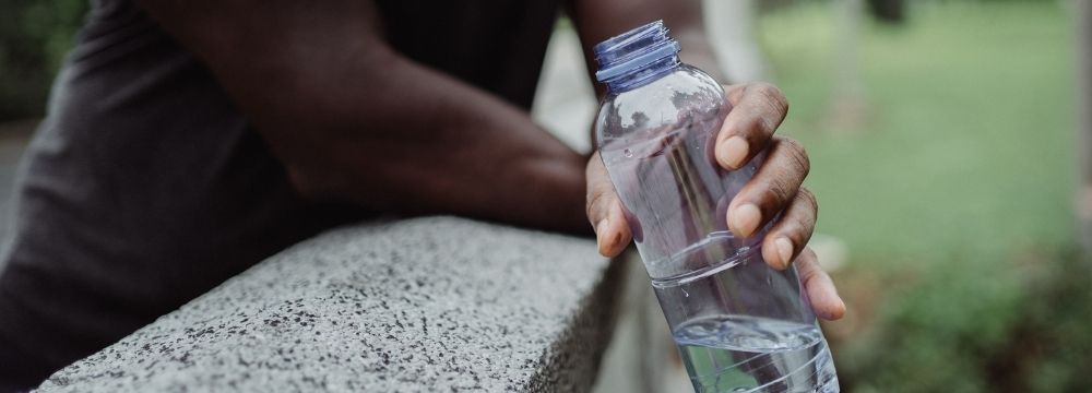 Man prioritizes hydration as he exercises for his heart health as recommended by cardiologists at Huntington Heart Center 