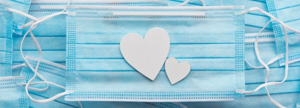 Hearts on top of medical face masks illustrate concerns about COVID-19 and the heart as discussed by experts at Huntington Heart Center 